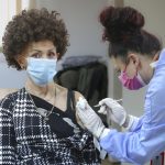 A woman is administered a COVID-19 vaccine at a center on the outskirts of Sarajevo, Bosnia, Sunday, Dec. 12, 2021. Some vaccine late-takers in Bosnia say they recently decided to finally embrace Covid-19 shots after numerous European countries started tightening their anti-virus rules, including by requiring proof of vaccination from foreign visitors before letting them in and giving them access to public venues within their borders. (AP Photo)