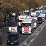 A convoy of trucks with banners reading ‘SOS, Transport. We can’t hold out any longer’ and ‘That’s enough’ drive slowly during a protest in the Castellana boulevard in Madrid, Spain, Wednesday, Dec. 15, 2021. Governments worldwide are facing protests, work stoppages or other political pressure to take action against soaring inflation. Spanish truck drivers ratcheted up the pressure by vowing a walkout days before Christmas and won relief on diesel prices, while Turkish citizens are protesting the government’s unorthodox economic policies that have worsened surging inflation and made it a struggle to buy food and other goods. (AP Photo/Paul White)