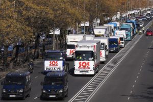 A convoy of trucks with banners reading ‘SOS, Transport. We can’t hold out any longer’ and ‘That’s enough’ drive slowly during a protest in the Castellana boulevard in Madrid, Spain, Wednesday, Dec. 15, 2021. Governments worldwide are facing protests, work stoppages or other political pressure to take action against soaring inflation. Spanish truck drivers ratcheted up the pressure by vowing a walkout days before Christmas and won relief on diesel prices, while Turkish citizens are protesting the government’s unorthodox economic policies that have worsened surging inflation and made it a struggle to buy food and other goods. (AP Photo/Paul White)
