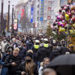 Despite rainy weather, Duesseldorf’s city centre is well frequented despite the Corona rules for retailers, shortly before Christmas in Duesseldorf, Germany, Saturday, Dec. 18, 2021. (Malte Krudewig/dpa via AP)