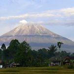 Mount Semeru is seen in Lumajang district, East Java province, Indonesia, Saturday, Dec. 18, 2021. Indonesian authorities raised the alert level for the highest volcano on Java island, saying Mount Semeru could blow up again after a sudden eruption earlier this month that killed a number of people and left thousands homeless in villages that were buried in layers of mud. (AP Photo/Hendra Permana)