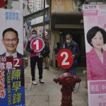 Banners of pro-establishment candidates, Regina Ip Lau Suk-yee, right, and Cham Hok-fung are displayed on a street for the legislative election in Hong Kong, Sunday, Dec. 19, 2021. Hong Kong was voting Sunday in the first election since Beijing amended the laws that reduced the number of directly elected lawmakers and vetted candidates to ensure that only those loyal to China can run. (AP Photo/Kin Cheung)