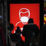 A government digital poster encouraging people to wear face masks to curb the spread of coronavirus, is displayed in a bus stop in London, Friday, Dec. 17, 2021. After the U.K. recorded its highest number of confirmed new COVID-19 infections since the pandemic began, France announced Thursday that it would tighten entry rules for those coming from Britain. Hours later, the country set another record, with a further 88,376 confirmed COVID-19 cases reported Thursday, almost 10,000 more than the day before. (AP Photo/Matt Dunham)