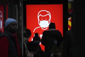 A government digital poster encouraging people to wear face masks to curb the spread of coronavirus, is displayed in a bus stop in London, Friday, Dec. 17, 2021. After the U.K. recorded its highest number of confirmed new COVID-19 infections since the pandemic began, France announced Thursday that it would tighten entry rules for those coming from Britain. Hours later, the country set another record, with a further 88,376 confirmed COVID-19 cases reported Thursday, almost 10,000 more than the day before. (AP Photo/Matt Dunham)