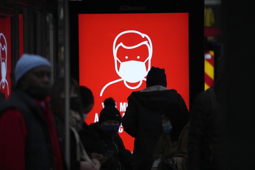A government digital poster encouraging people to wear face masks to curb the spread of coronavirus, is displayed in a bus stop in London, Friday, Dec. 17, 2021. After the U.K. recorded its highest number of confirmed new COVID-19 infections since the pandemic began, France announced Thursday that it would tighten entry rules for those coming from Britain. Hours later, the country set another record, with a further 88,376 confirmed COVID-19 cases reported Thursday, almost 10,000 more than the day before. (AP Photo/Matt Dunham)