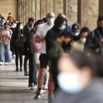 Members of the public queue to take a COVID-19 tests in Sydney, Tuesday, Dec. 28, 2021. Australia’s Victoria and Queensland states reported record levels of new daily coronavirus infections on Tuesday as pressure on testing centers prompted calls for wider use of rapid antigen tests. (Brendon Thorne/AAP Image via AP)