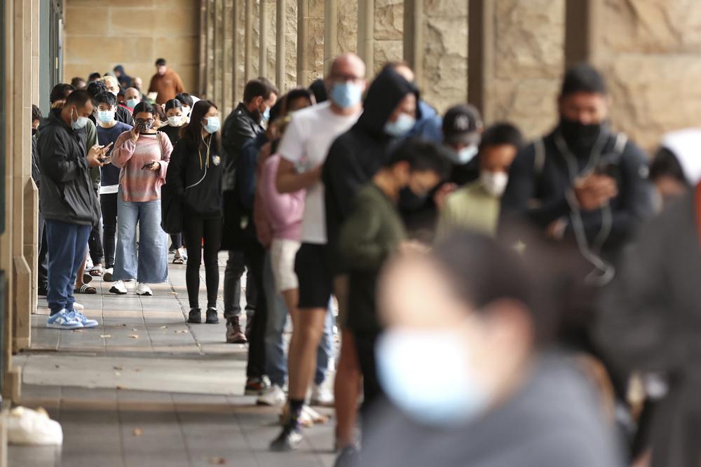 Members of the public queue to take a COVID-19 tests in Sydney, Tuesday, Dec. 28, 2021. Australia’s Victoria and Queensland states reported record levels of new daily coronavirus infections on Tuesday as pressure on testing centers prompted calls for wider use of rapid antigen tests. (Brendon Thorne/AAP Image via AP)
