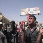 People protests against the October military coup and subsequent deal that reinstated Prime Minister Abdalla Hamdok in Khartoum, Sudan, Monday, Dec. 13, 2021. (AP Photo/Marwan Ali)