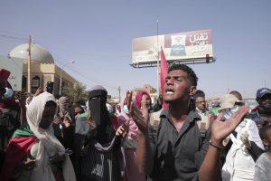 People protests against the October military coup and subsequent deal that reinstated Prime Minister Abdalla Hamdok in Khartoum, Sudan, Monday, Dec. 13, 2021. (AP Photo/Marwan Ali)