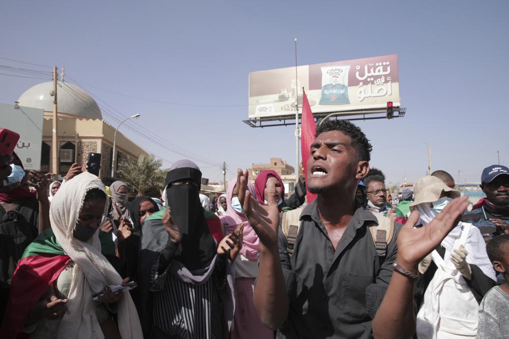 People protests against the October military coup and subsequent deal that reinstated Prime Minister Abdalla Hamdok in Khartoum, Sudan, Monday, Dec. 13, 2021. (AP Photo/Marwan Ali)