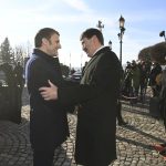 French President Emmanuel Macron, left, is welcomed by his Hungarian counterpart Janos Ader, right, at the presidential Alexander Palace in Budapest, Hungary, Monday, Dec. 13, 2021. (Noemi Bruzak/MTI via AP)