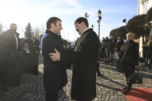 French President Emmanuel Macron, left, is welcomed by his Hungarian counterpart Janos Ader, right, at the presidential Alexander Palace in Budapest, Hungary, Monday, Dec. 13, 2021. (Noemi Bruzak/MTI via AP)