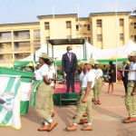 NYSC Lagos State Coordinator Mr Eddy Megwa watching march-past of corps members on Tuesday