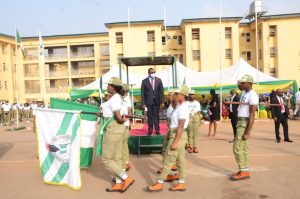 NYSC Lagos State Coordinator Mr Eddy Megwa watching march-past of corps members on Tuesday