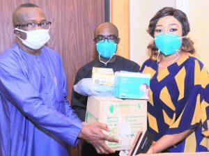 Sen Ndoma Egbe handing over some of the items to the Commissioner for Health, Dr Beta Edu, in Calabar
