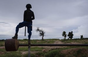 A civilian vigilante nicknamed Madman serves as a lookout along the last line of defense for the southeastern flank of Maiduguri, the biggest city in northeastern Nigeria, Aug. 22, 2019. (Laura Boushnak/The New York Times)