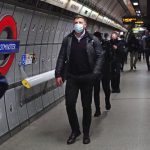 Commuters, some wearing face masks to curb the spread of COVID-19, walk at Westminster underground station in central London, Monday Dec. 20, 2021. Britain’s health secretary has refused to rule out imposing tougher COVID-19 restrictions before Christmas amid the rapid rise of infections and continuing uncertainty about the omicron variant. (Victoria Jones/PA via AP)