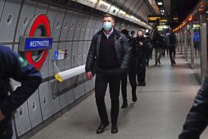 Commuters, some wearing face masks to curb the spread of COVID-19, walk at Westminster underground station in central London, Monday Dec. 20, 2021. Britain’s health secretary has refused to rule out imposing tougher COVID-19 restrictions before Christmas amid the rapid rise of infections and continuing uncertainty about the omicron variant. (Victoria Jones/PA via AP)