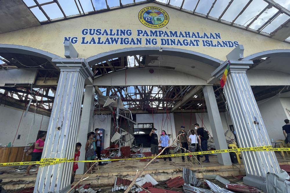 In this photo provided by the Office of the Vice President, Philippine Vice President Leni Robredo, center, inspects damages due to Typhoon Rai at Dinagat islands, southern Philippines on Sunday Dec. 19, 2021. The death toll continues to rise following the strongest typhoon to batter the Philippines this year, with several central towns and provinces still grappling with downed communications and power outages and pleading for food and water, officials said Monday. (Office of the Vice President via AP)