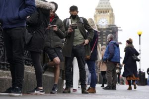 People queue on Westminster Bridge for booster jabs at St Thomas’ Hospital, London, Monday, Dec. 13, 2021. Britain faces a “tidal wave” of infections from the omicron coronavirus variant and British Prime Minister Boris Johnson has announced a huge increase in booster vaccinations to strengthen defenses against it. (Kirsty O’Connor/PA via AP)