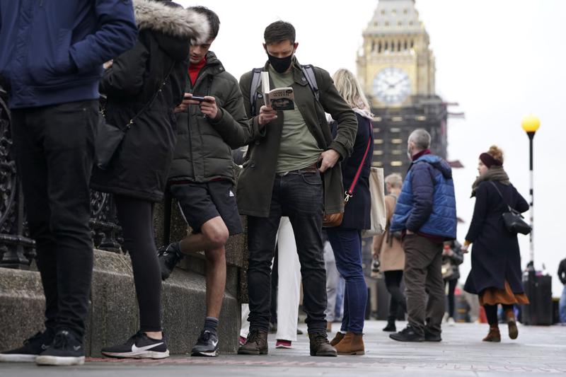 People queue on Westminster Bridge for booster jabs at St Thomas’ Hospital, London, Monday, Dec. 13, 2021. Britain faces a “tidal wave” of infections from the omicron coronavirus variant and British Prime Minister Boris Johnson has announced a huge increase in booster vaccinations to strengthen defenses against it. (Kirsty O’Connor/PA via AP)
