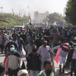 People take part in a protest against the October military takeover and a subsequent deal that reinstated Prime Minister Abdalla Hamdok but sidelined the movement in Khartoum, Sudan, Sunday, Dec. 19, 2021. (AP Photo/Marwan Ali)