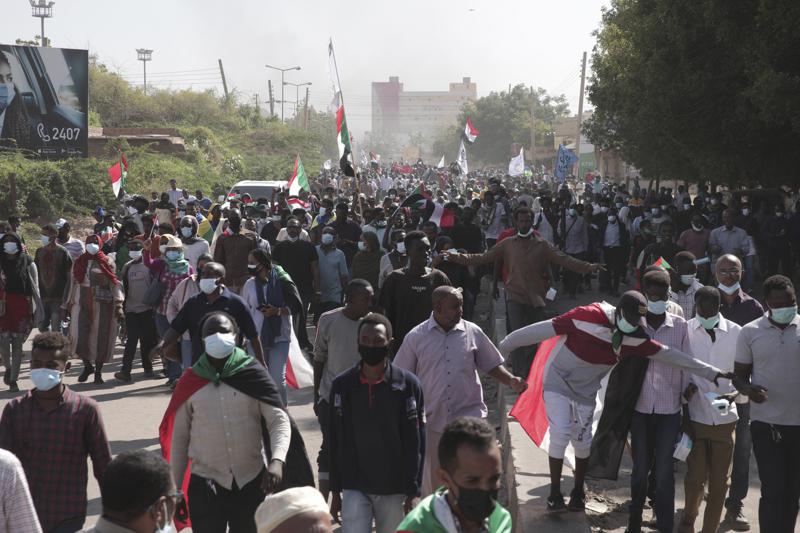People take part in a protest against the October military takeover and a subsequent deal that reinstated Prime Minister Abdalla Hamdok but sidelined the movement in Khartoum, Sudan, Sunday, Dec. 19, 2021. (AP Photo/Marwan Ali)