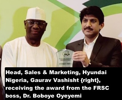 Head, Sales & Marketing, Hyundai Nigeria, Gaurav Vashisht {right}, receiving the award from the FRSC boss,Dr. Boboye Oyeyemi