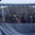 FILE – People queue in line to wait for the coronavirus testing at a makeshift testing site in Seoul, South Korea on Dec. 22, 2021. Caseloads of omicron have remained relatively low in many countries in Asia. For now, many remain insulated from the worst, although the next few months will remain critical. (AP Photo/Ahn Young-joon, File)