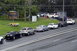 People line up in cars for COVID-19 tests at a clinic in Sydney, Wednesday, Dec. 29, 2021. Coronavirus cases are surging across Australia as an outbreak of the omicron variant spreads, with new infections in Sydney and surrounding parts of New South Wales state skyrocketing to more than 11,000, up from 6,000 a day earlier. (Mick Tsikas/AAP Image via AP)
