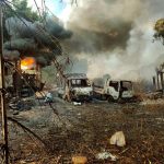 In this photo provided by the Karenni Nationalities Defense Force (KNDF), smokes and flames billow from vehicles in Hpruso township, Kayah state, Myanmar, Friday, Dec. 24, 2021. Myanmar government troops rounded up villagers, some believed to be women and children, fatally shot more than 30 and set the bodies on fire, a witness and other reports said Saturday. (KNDF via AP)