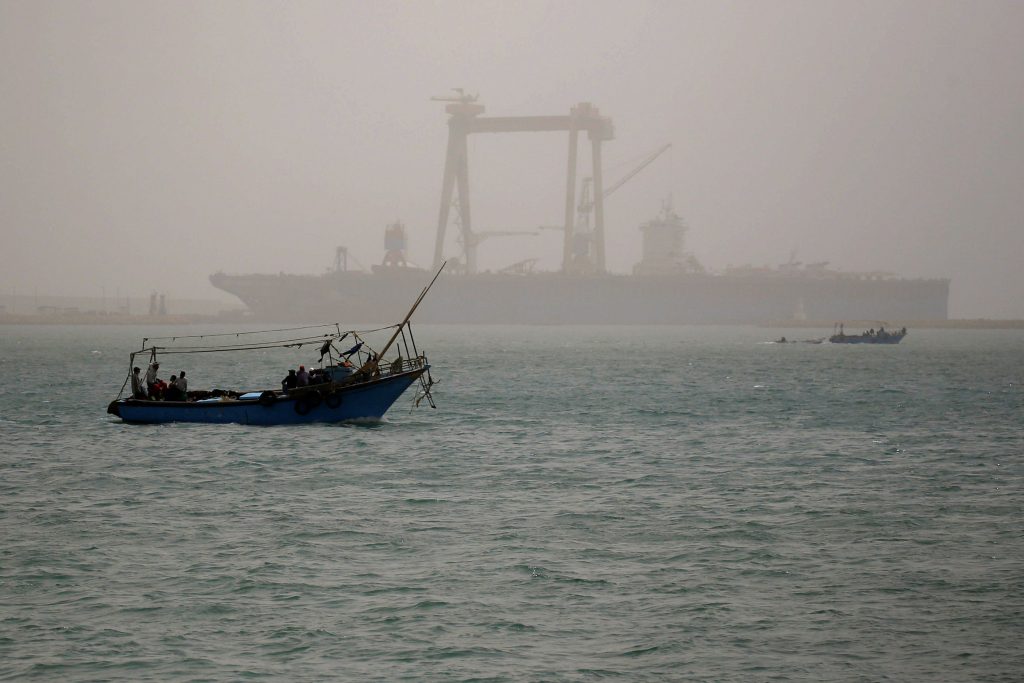 A boat is seen on a dusty weather in Suez near the Suez Canal