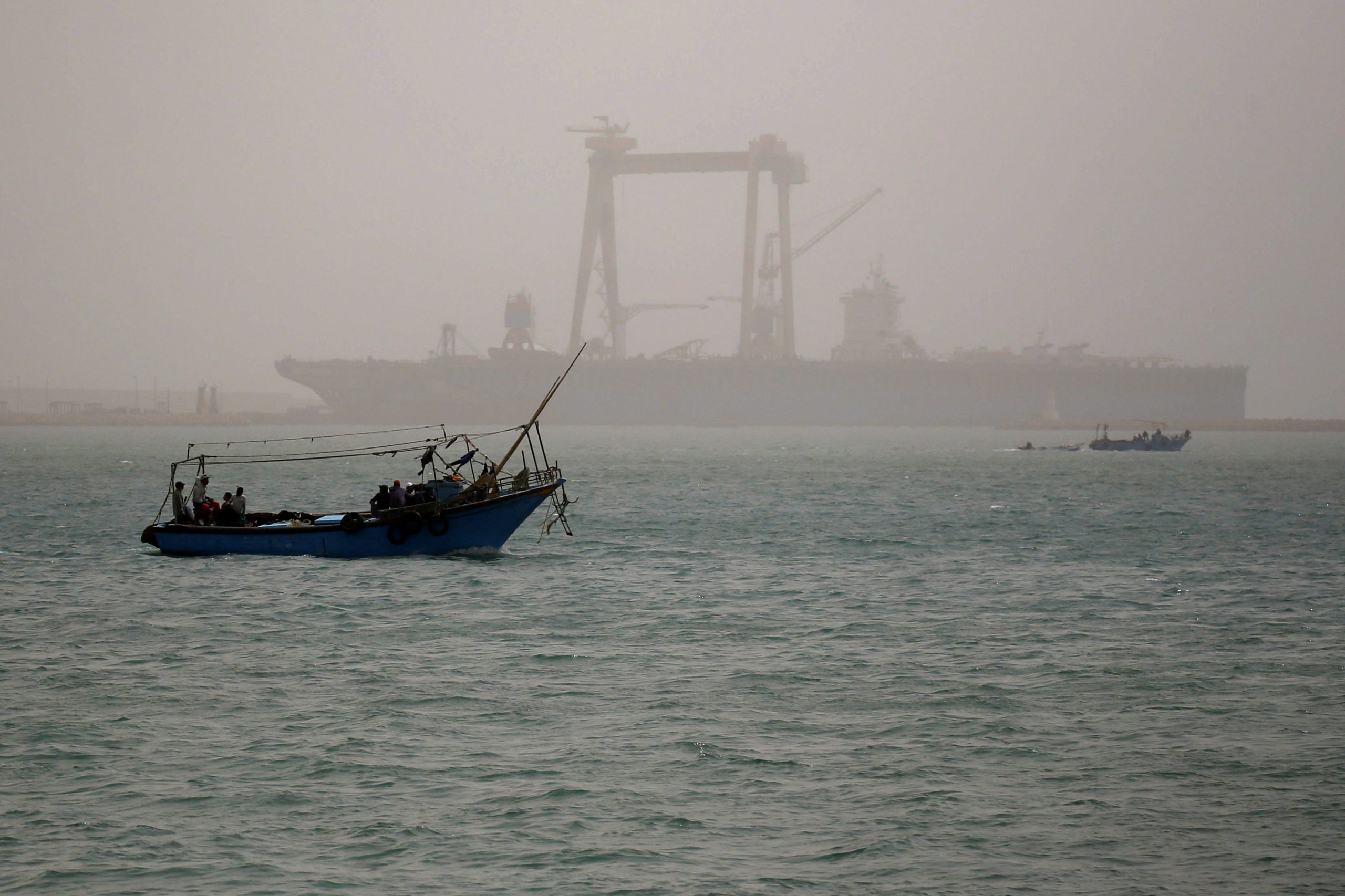 A boat is seen on a dusty weather in Suez near the Suez Canal