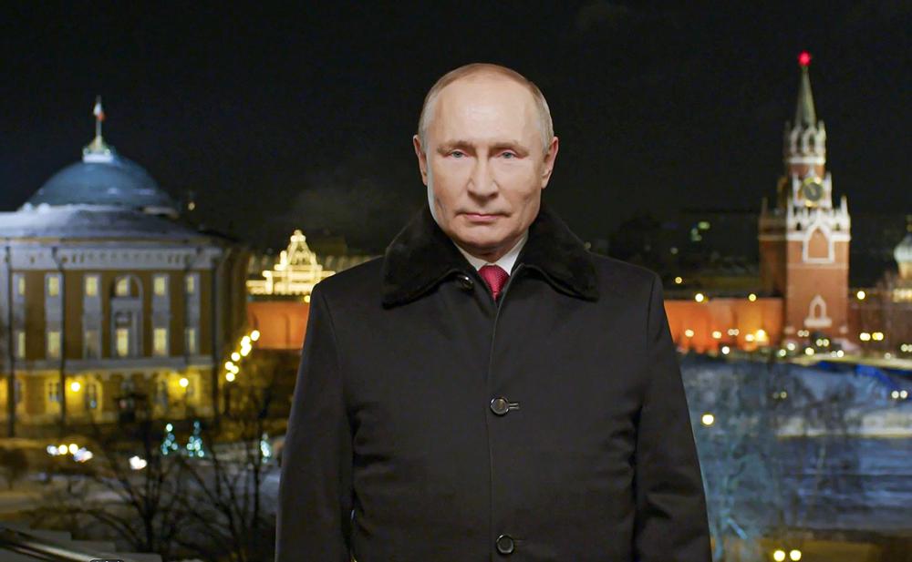 In this photo released by Kremlin Press service on Saturday, Jan. 1, 2022, Russian President Vladimir Putin speaks during a recording of his annual televised New Year’s message on New Year’s eve in the Kremlin in Moscow, Russia. Russian President Vladimir Putin on Friday wished Russians positive changes in the new year, hailing their solidarity and strength in the face of tough challenges like the coronavirus pandemic. President Vladimir Putin is wishing Russians a happier new year, hailing their solidarity and strength in the face of tough challenges like the coronavirus pandemic. In a televised address broadcast just before midnight in each of Russia’s 11 time zones, Putin said the nation has faced “colossal challenges but has learned to live in those harsh conditions and solve difficult tasks thanks to our solidarity.” Putin’s address to the nation on Friday was broadcast hours after his phone call with U.S. President Joe Biden, which focused on next month’s talks to discuss Moscow’s demand for Western security guarantees amid a Russian troop buildup near Ukraine.(Kremlin Pool Photo via AP)