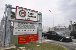 A vehicle leaves the U.S. Marine Corps’ Camp Hansen, in Kin, Okinawa prefecture, southern Japan, on Jan. 5, 2022. The U.S. military on Thursday, Jan. 6, ordered personnel stationed in Japan to wear masks when going off base to curb the spread of COVID-19 infections. (Kyodo News via AP)