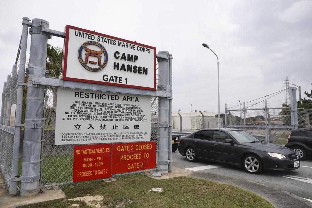 A vehicle leaves the U.S. Marine Corps’ Camp Hansen, in Kin, Okinawa prefecture, southern Japan, on Jan. 5, 2022. The U.S. military on Thursday, Jan. 6, ordered personnel stationed in Japan to wear masks when going off base to curb the spread of COVID-19 infections. (Kyodo News via AP)