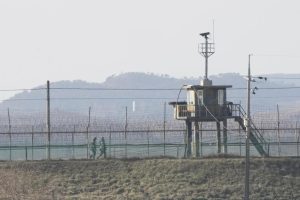 South Korean army soldiers patrol along the barbed-wire fence in Paju, near the border with North Korea, South Korea, Sunday, Jan. 2, 2022. South Korea’s military said Sunday that an unidentified person crossed the heavily fortified border into North Korea. (AP Photo/Ahn Young-joon)