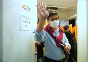 Chris Yeung, founder and chief writer of Citizen News waves to journalists after a press conference outside his office in Hong Kong Monday, Jan. 3, 2022. The Hong Kong online news site said Sunday that it would cease operations in light of deteriorating press freedoms, days after police raided and arrested seven people for sedition at a separate pro-democracy news outlet. Citizen News announced its decision in a Facebook post Sunday. It said it would stop updating its site on Jan. 4, and it would be shuttered after that. (AP Photo/Vincent Yu)