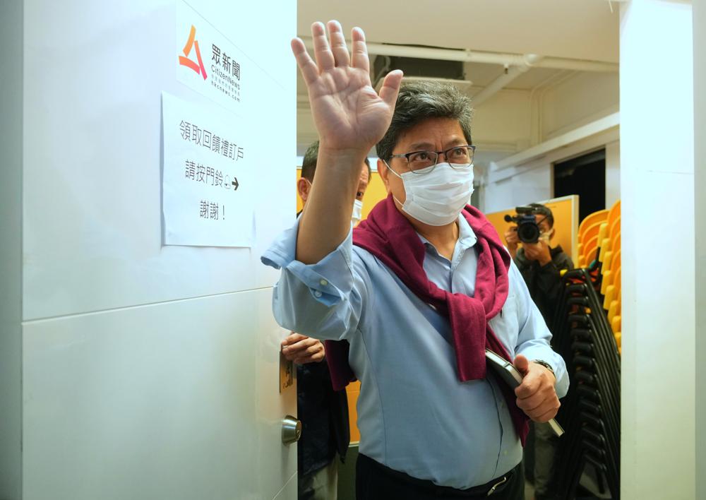 Chris Yeung, founder and chief writer of Citizen News waves to journalists after a press conference outside his office in Hong Kong Monday, Jan. 3, 2022. The Hong Kong online news site said Sunday that it would cease operations in light of deteriorating press freedoms, days after police raided and arrested seven people for sedition at a separate pro-democracy news outlet. Citizen News announced its decision in a Facebook post Sunday. It said it would stop updating its site on Jan. 4, and it would be shuttered after that. (AP Photo/Vincent Yu)