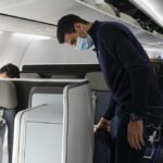 Novak Djokovic prepares to take his seat on a plane to Belgrade, in Dubai, United Arab Emirates, Monday, Jan. 17, 2022. Djokovic was deported from Australia on Sunday after losing a bid to stay in the country to defend his Australian Open title despite not being vaccinated against COVID-19.(AP Photo/Darko Bandic)