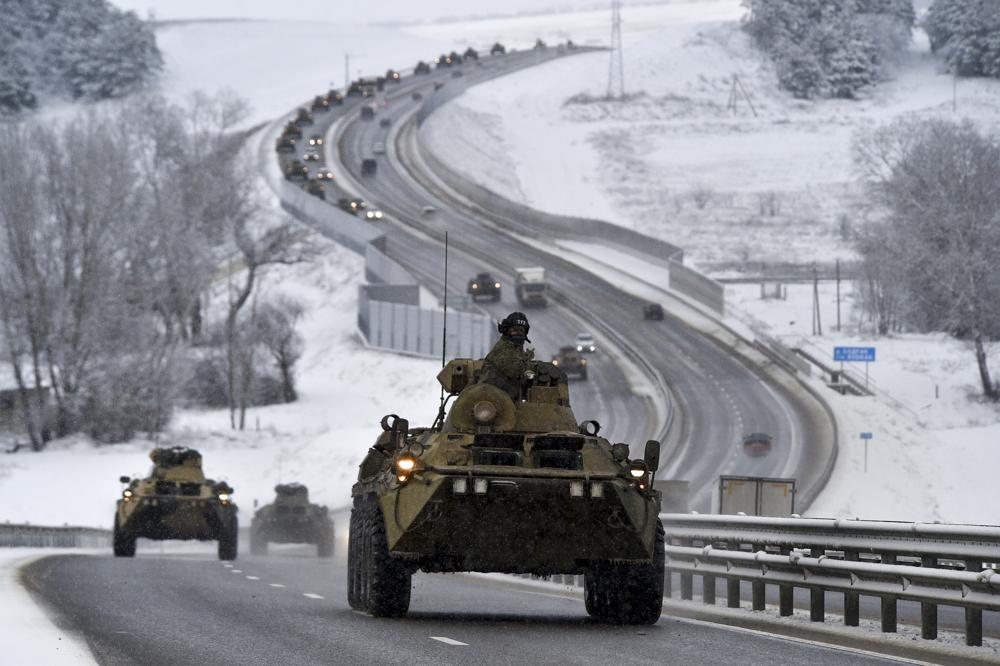 FILE – A convoy of Russian armored vehicles moves along a highway in Crimea, Tuesday, Jan. 18, 2022. With tens of thousands of Russian troops positioned near Ukraine, the Kremlin has kept the U.S. and its allies guessing about its next moves in the worst Russia-West security crisis since the Cold War. (AP Photo, File)