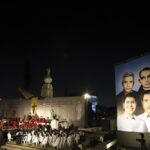A poster depicting the Rev. Rutilio Grande, Franciscan priest Cosme Spessotto, Nelson Lemus and Manuel Solorzano, all victims of right-wing death squads during El Salvador’s civil war, is displayed during their beatification ceremony in San Salvador, Saturday, Jan. 22, 2022. (AP Photo/Salvador Melendez)