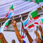 APC-members-holding-party-flag-1200×675