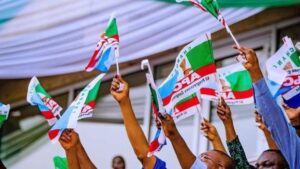 APC-members-holding-party-flag-1200×675