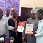 Pam Jang receiving PDP nomination form from his League of Friends in Jos
