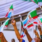 APC-members-holding-party-flag-1200×675-1