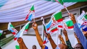 APC-members-holding-party-flag-1200×675-1