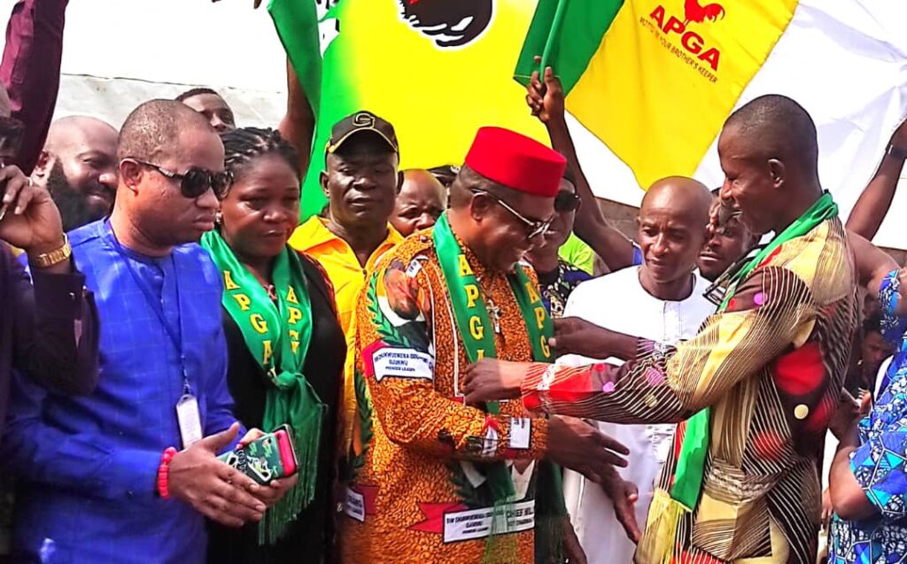 IMG-Ozoemena (centre) being decorated the State APGA Chairman (right) as others watch in admiration