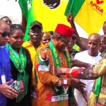 IMG-Ozoemena (centre) being decorated the State APGA Chairman (right) as others watch in admiration