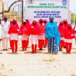 Headmistress, Muhammadu Buhari Academy, Maiduguri,  Hajia Amina Mustapha Haruna and students, welcome Jose Foundation UK Team for COVID-19 Global Sensitisation Campaign to the school